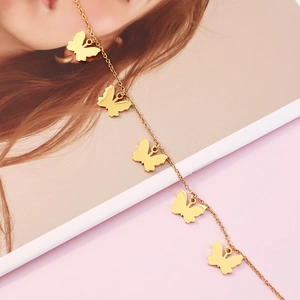 Minimalist gold butterfly necklace featuring five delicate butterfly pendants on a thin chain