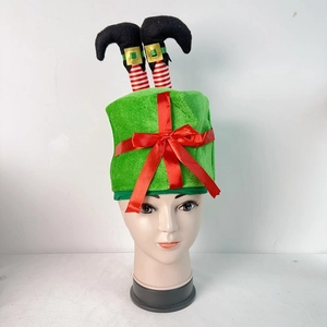Detail of green elf leg Christmas hat with striped socks and red ribbon bow decoration