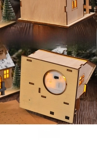 Detail of wooden Christmas house back view with LED switch and battery compartment