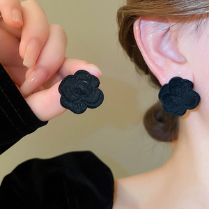 Detailed view of elegant black flocked camellia flower stud earrings for women