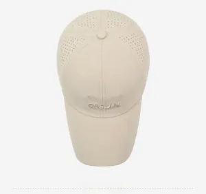 Detail of breathable laser-cut holes and casual 3D embroidery on a beige baseball cap