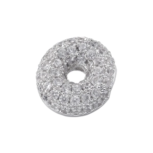 Macro detail of silver round charm featuring full pavé cubic zirconia setting