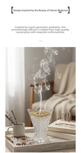 Detail of crystal glass aroma burner with gold rim on a wooden tray with books