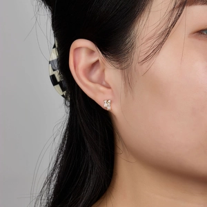 Minimalist S925 silver stud earring with square zircon shown on a female model's ear