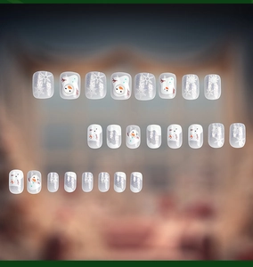 Detailed view of 24pcs Christmas press-on nails with snowman, snowflake, and silver glitter
