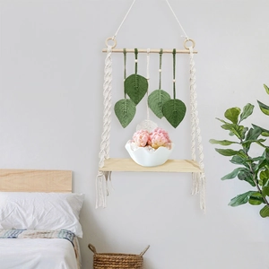 Boho woven wall hanging shelf with green leaf tassel decor and wooden storage tray