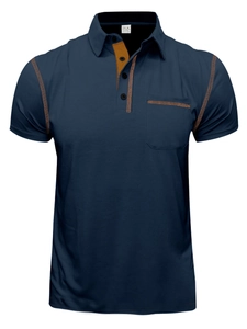 Detail of navy blue polo shirt featuring orange contrast stitching and chest pocket detail