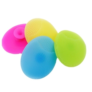 Set of four colorful oval silicone facial cleansing brushes in pink yellow blue and green