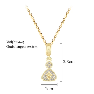 Macro view of gold S-letter pendant with crystal inlay and detailed size measurements