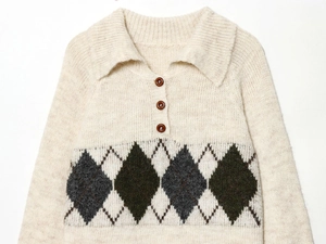Macro detail of knit texture and buttons on argyle pattern polo sweater