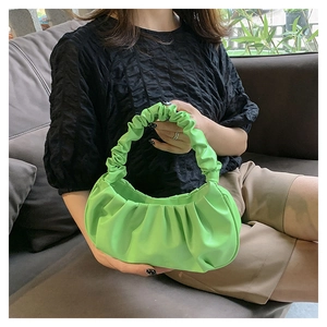 Close-up of vibrant green cloud bag featuring a unique gathered handle and soft PU leather