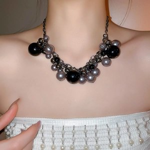 Irregular faux pearl tassel necklace in dark gothic style worn by model for fashion styling