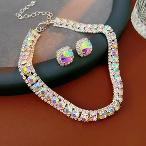 Detail of silver jewelry set featuring iridescent crystals on necklace and earrings