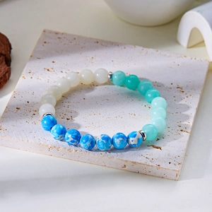 Macro shot of 8mm gradient natural stone beads and metal spacers on a stretch bracelet