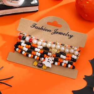 Halloween multilayer beaded bracelet set with ghost and bat charms on orange background