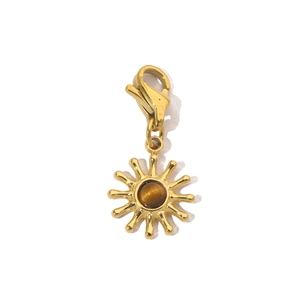 Macro detail of sun-shaped pendant with brown tiger eye stone and lobster clasp