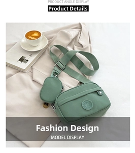 Detail of mint green oxford crossbody bag with matching round coin purse and metal buckle