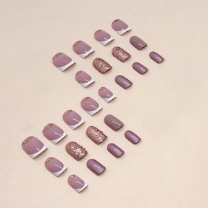 Short French press-on nails with white tips and rose gold glitter powder accents