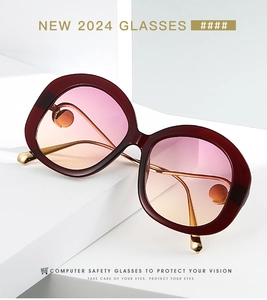 Detail of round burgundy frames with pink gradient lenses and gold metal temples