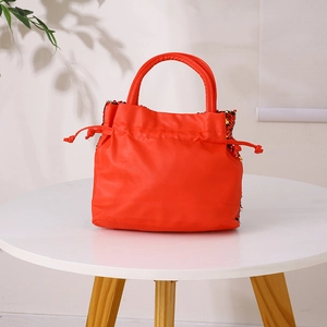 Detail of red sequin handbag for girls with leather trim and drawstring closure