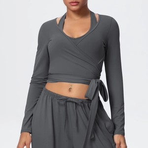 Detail of dark grey cross-wrap long sleeve yoga top with adjustable waist tie