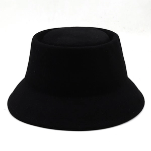 Close-up of the smooth black wool felt texture and curved brim of the bucket hat