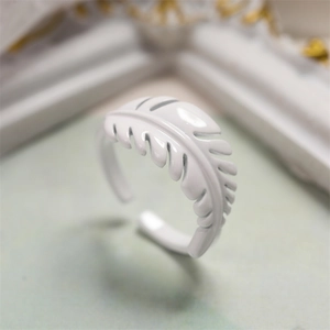 Macro shot of white leaf shaped lacquer ring with adjustable metal opening detail