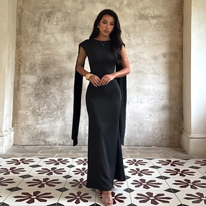 Elegant black backless slim-fit evening gown with long ribbons in vintage interior
