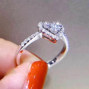 Macro shot of heart-shaped cluster ring with silver finish and pavé cubic zirconia