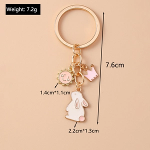 Detail view of pink crown and white bunny keychain charms with measurements and weight