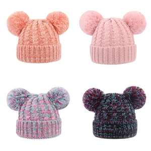 Winter knit beanies for toddlers featuring double faux fur pom poms and cable knit pattern