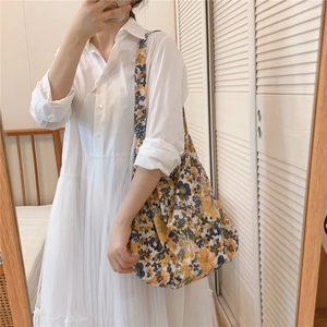 Detail of floral canvas tote bag with vintage blue and yellow flower patterns
