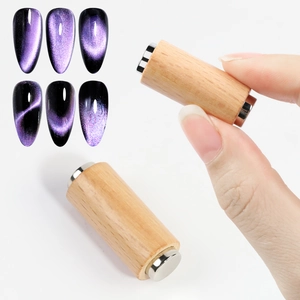 Dual wood-handle cylindrical magnets creating professional cat eye nail art effects
