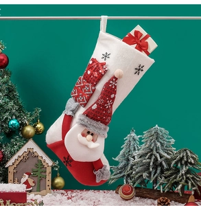 Close-up of a red plush Christmas stocking featuring a 3D Santa Claus and gift box