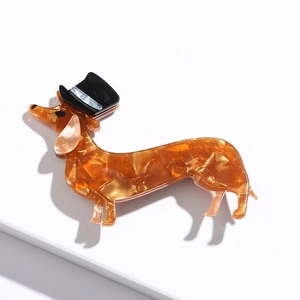 Dachshund design acetate brooch in amber tortoiseshell with a small black hat