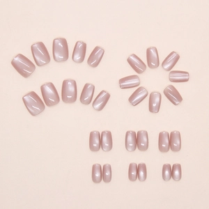Macro detail of champagne pink cat-eye press-on nails with silky pearl finish texture