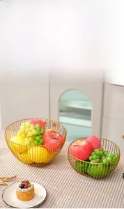 Detail of Nordic golden wire fruit baskets in large and small geometric metal designs