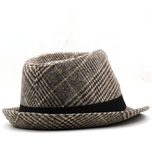 Detailed view of the gray plaid wool texture and black decorative ribbon on the jazz hat