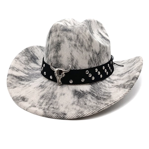 Detailed view of western cowboy hat featuring bull skull ornament and silver studded band