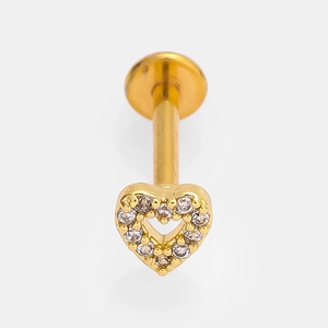 Detail of a golden heart labret stud with inlaid clear crystals on a white background