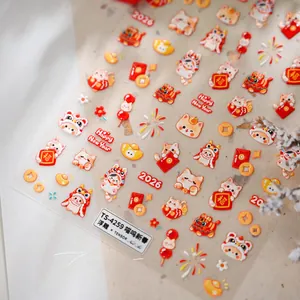 Detail of 3D embossed New Year nail stickers featuring Lucky Cat, red envelopes and gold coins
