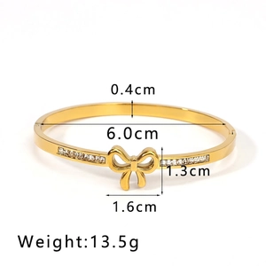 Detail shot of golden bow bangle with dimensions showing 6.0cm diameter and 0.4cm width