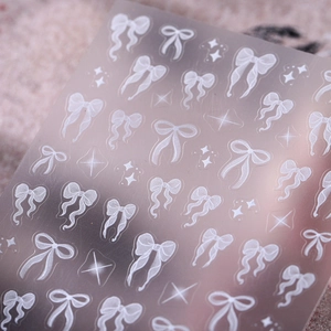 5D embossed nail art stickers featuring white ribbon bows and stars on matte background