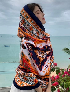 Detail of bohemian floral print beach shawl with hood showing ethnic patterns and vibrant colors