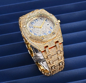 Macro side view of gold stainless steel watch band and casing with full diamond pavé inlay