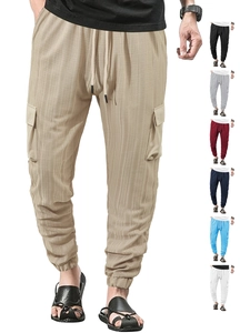 Detail of cargo pants showing side pockets, drawstring waist and elastic cuffs in khaki