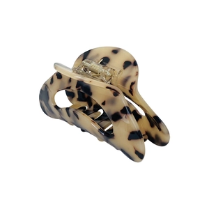 Minimalist moon-shaped tortoiseshell hair claw with beige and black resin pattern