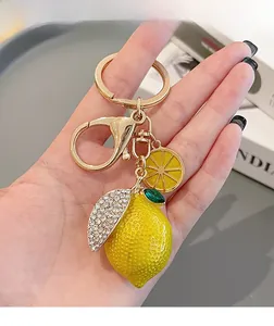 Macro detail of lemon keychain with sparkling rhinestones and golden hardware clasp