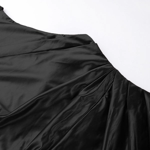 Detail shot of black satin dress showing premium pleated texture and silky fabric finish