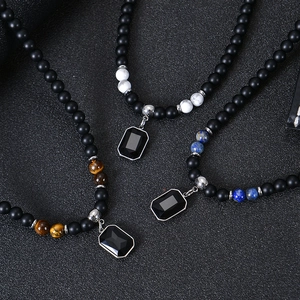 Detail of beaded necklaces with tiger eye, marble, and lapis lazuli stone pendants